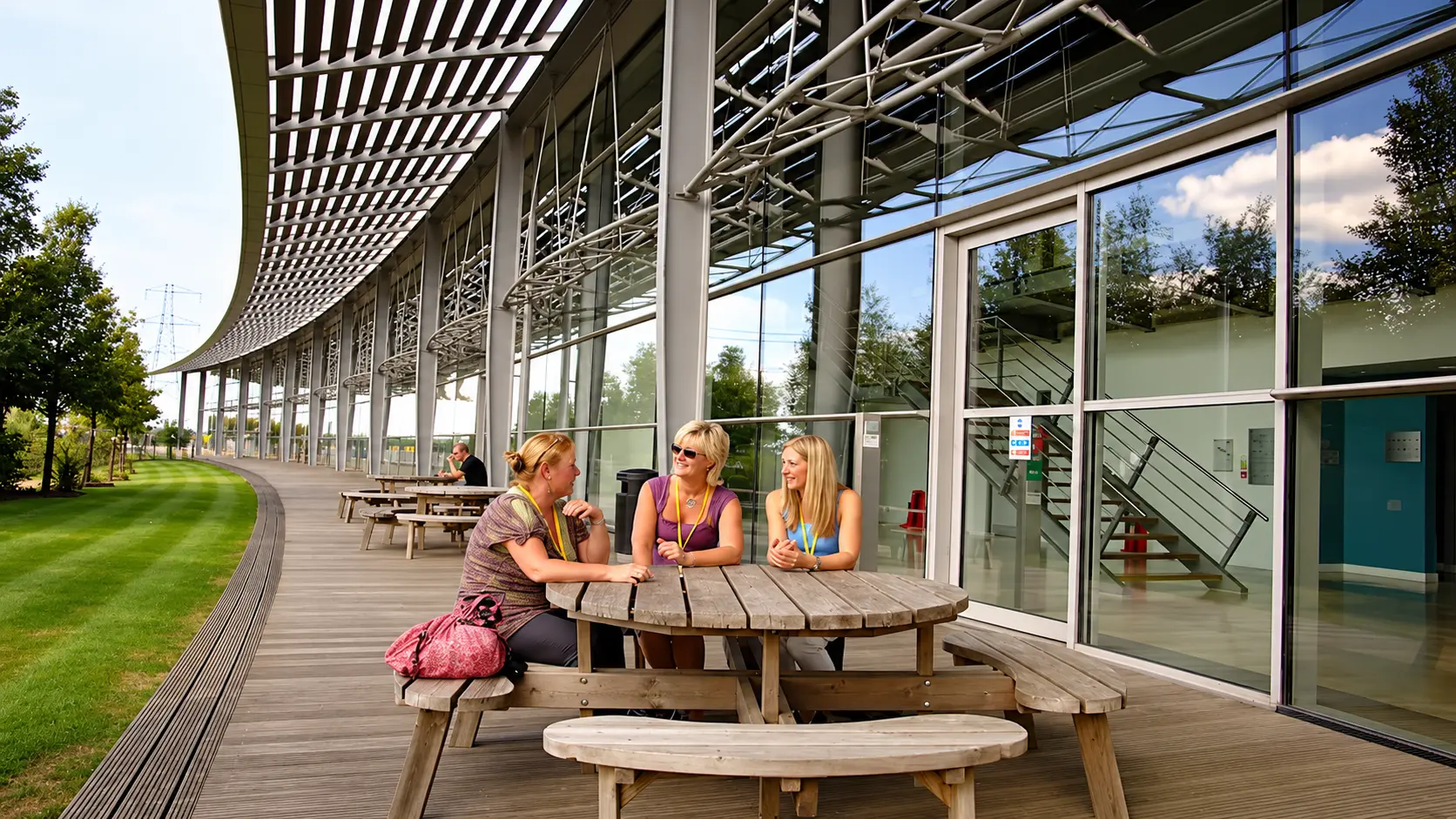 Outdoor deck seating beside the campus gardens