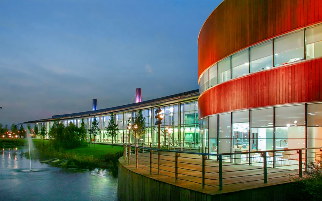 CEME Campus exterior at dusk with lake and fountains